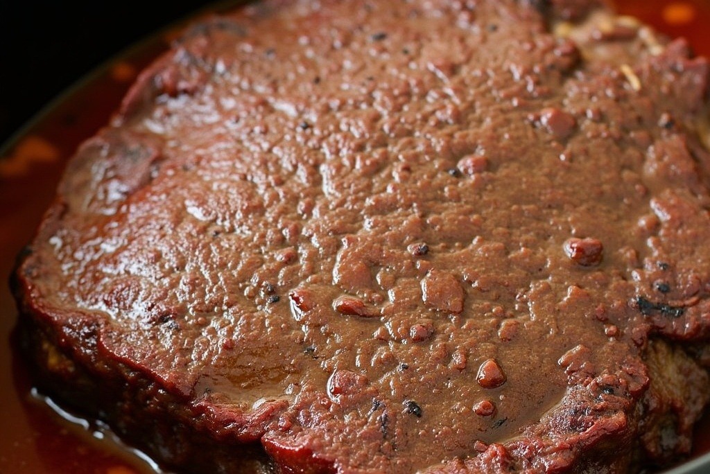 Beef chuck roast cooking in slow cooker